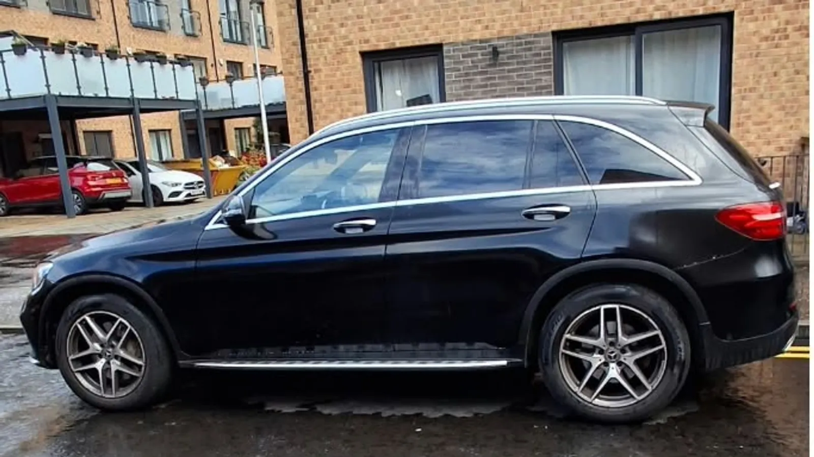 A black Mercedes SUV freshly valeted outside modern residential flats near Ocean Terminal in Leith, Edinburgh
